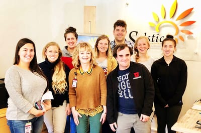 Staff members posing in a common area