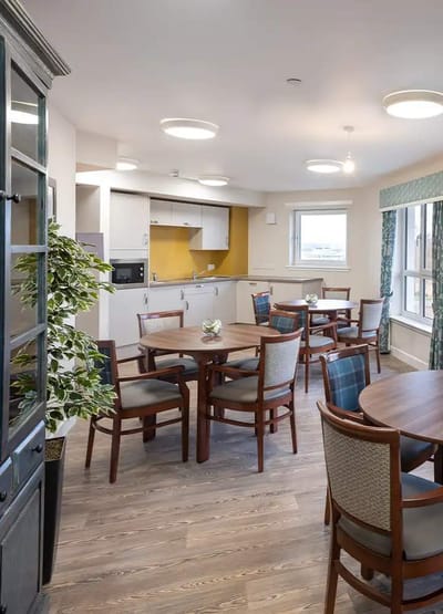 Common area with tables and chairs in the facility