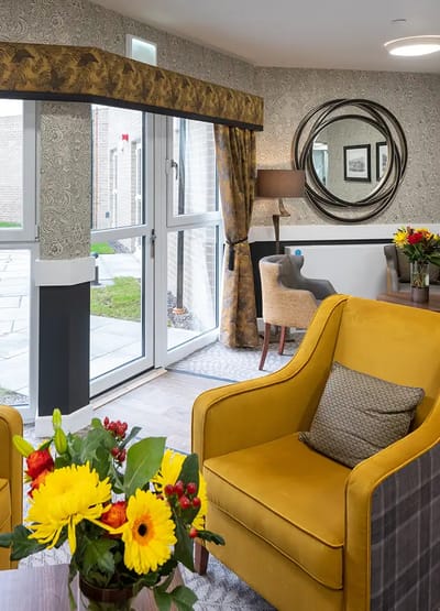 Cozy common area with floral arrangements and seating.