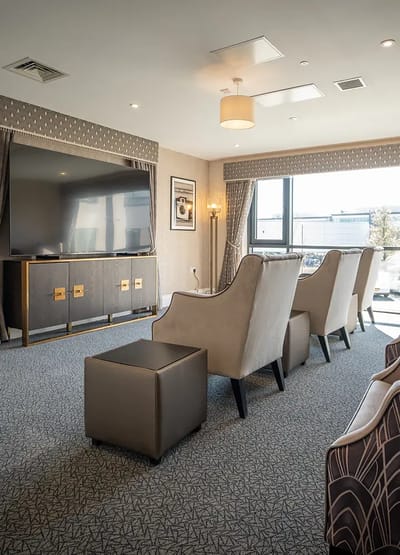 Comfortable lounge area with armchairs and television.