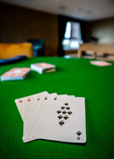 Close-up of playing cards on a green table