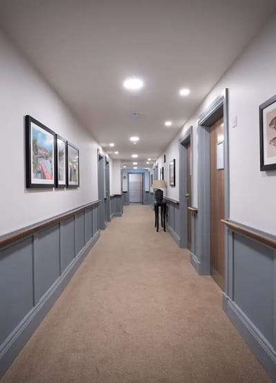 Interior hallway with framed artwork and doors