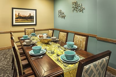 Well-set dining table in facility dining room.