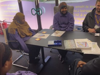 Two staff members interacting in a meeting room