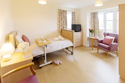 Comfortable private resident room with natural light.