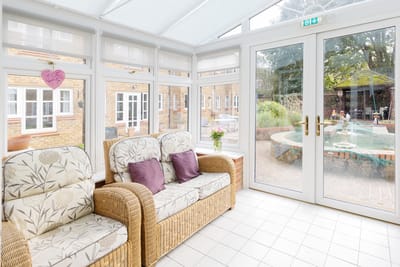 Comfortable seating area in a sunlit conservatory