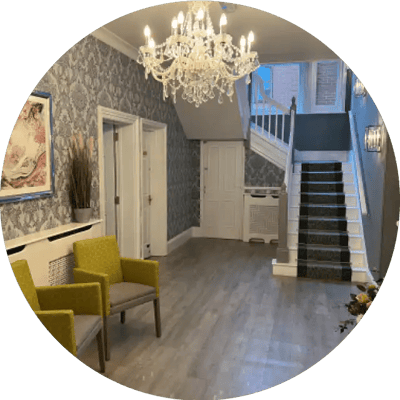 Elegant lobby area with chandelier and seating.