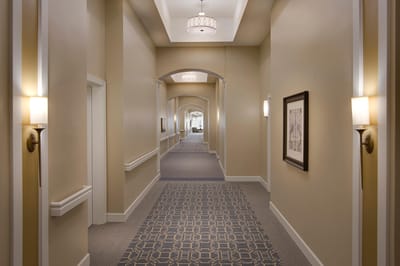 Well-lit hallway with stylish decor and artwork.