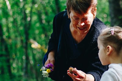 Senior woman interacting with a young girl outdoors