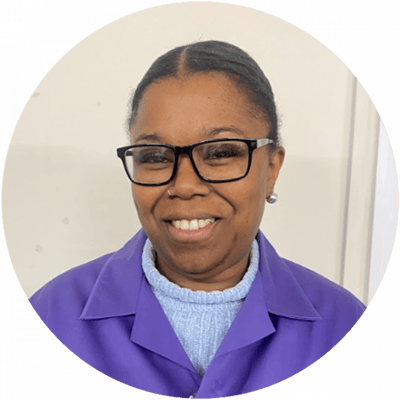 Smiling staff member in purple uniform