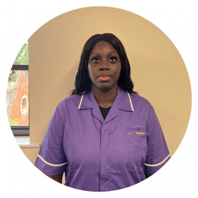 Staff member in a purple uniform indoors