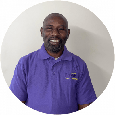 Staff member smiling in a purple shirt