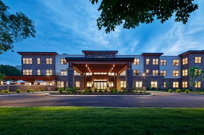 Exterior view of Maple Pointe Senior Living at dusk