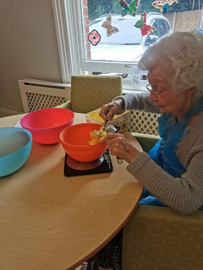 Senior woman baking in a colorful kitchen