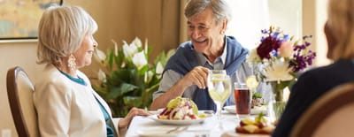 Residents enjoying a meal together in a dining area.