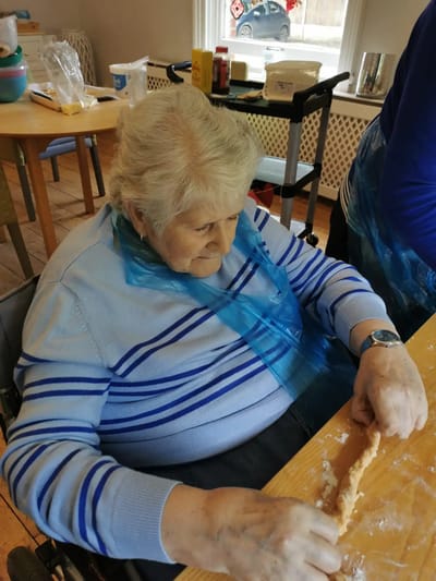 Senior resident participating in a cooking activity