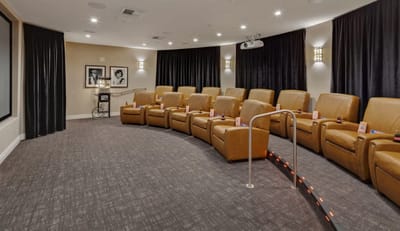 Cozy movie theater seating area with leather chairs.