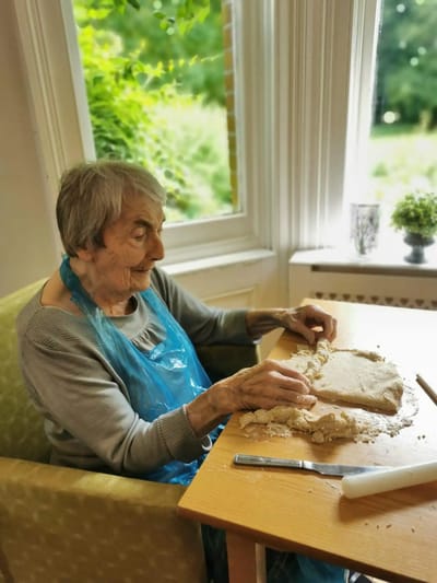 Senior resident engaging in a baking activity.