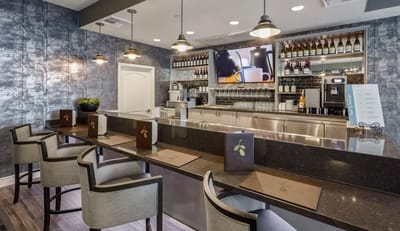 Modern cafe area with seating and bar counter