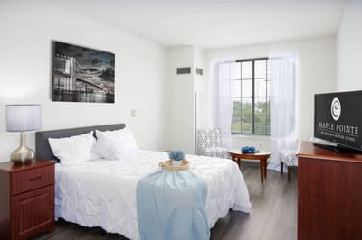 Comfortable senior living bedroom with seating area.