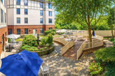 Lush outdoor courtyard with seating and trees