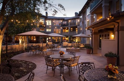 Outdoor courtyard with seating and evening lighting.