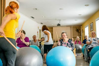 Residents participating in an exercise class with balls.
