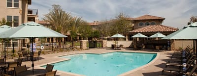 Outdoor pool area with umbrellas and seating