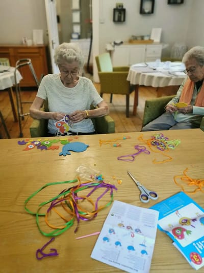 Residents engaged in a crafting activity together.