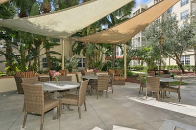 Outdoor patio area with seating and shade.