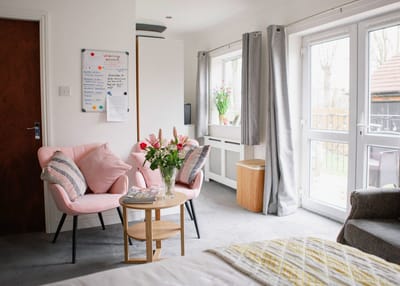 Bright interior common area with seating and flowers