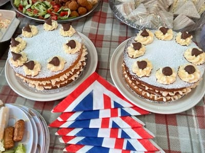 Two beautifully decorated cakes on a buffet table