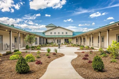 Courtyard view of a senior living facility with gardens