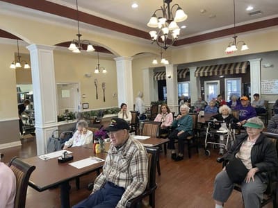 Residents gathered in a bright common area for an activity