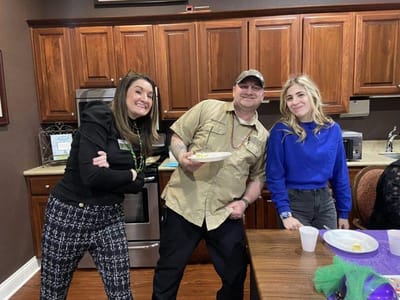 Staff and residents enjoying a social event in the kitchen
