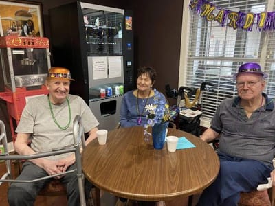 Residents celebrating with festive hats and decorations