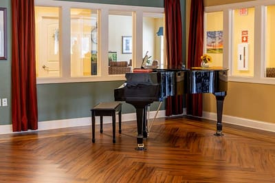 A grand piano in a well-lit common area