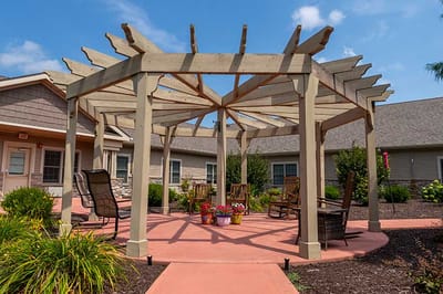 Outdoor seating area with overhead structure and garden