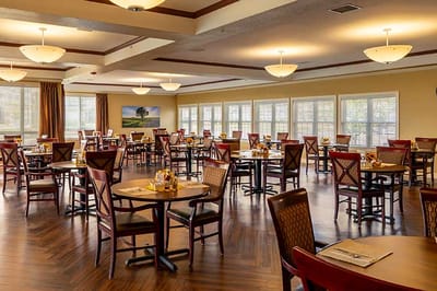 Bright dining room with tables set for meals