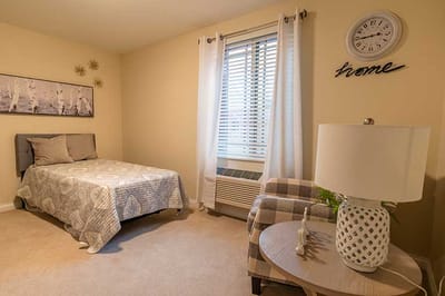 Cozy private resident room with bed and decor