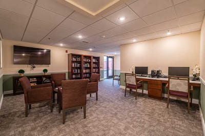 A cozy common area with seating and computers