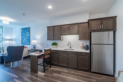 Cozy kitchenette and living area in a resident room