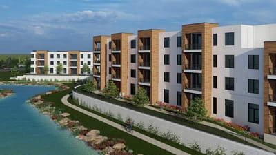 Exterior view of a modern assisted living facility by a serene water body