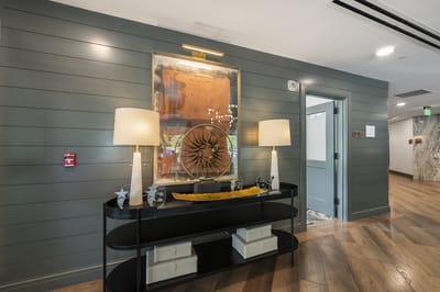 Interior decor of a hallway with artwork and lamps