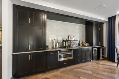 Interior view of a kitchen area with cabinets and appliances