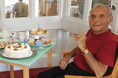 Resident enjoying a birthday cake with snacks