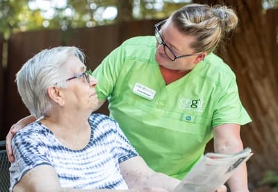 Staff member interacting with a resident outdoors