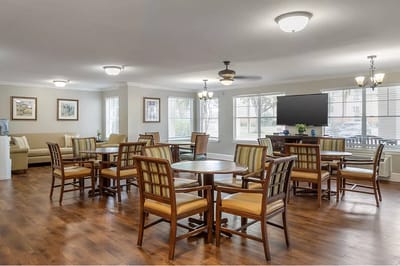 Bright dining area with wooden tables and chairs