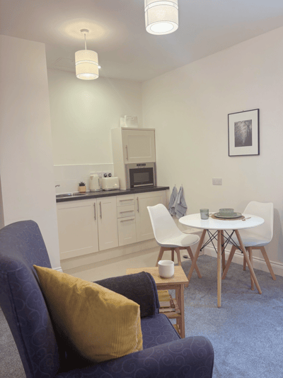 Cozy interior of a resident's room with a dining area
