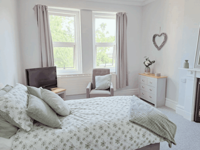 Cozy bedroom with natural light and floral bedding